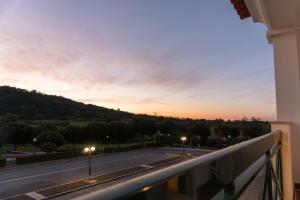a view of a street from a balcony at sunset at Hotel Estrela Da Idanha in Idanha-a-Nova