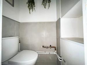 a small bathroom with a toilet and a sink at Suite Topaze in Lyon