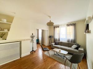 a living room with a couch and a table at Suite Topaze in Lyon