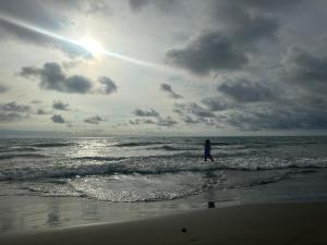 a person standing in the ocean on the beach at Playa Boquilla - Boquilla Beach - Apto con servicios de Hotel Sonesta in Cartagena de Indias