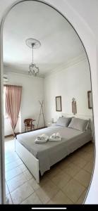 a bedroom with a large bed and a mirror at Casa Myda in Bari