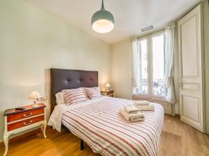 a bedroom with a bed with two towels on it at Belvilla by OYO Rambla Paris Apartment in Barcelona