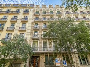 a large building with balconies on the side of it at Belvilla by OYO Rambla Paris Apartment in Barcelona