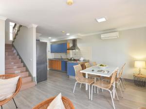 a kitchen and dining room with a table and chairs at Fantastic holiday home in Playa del Ingles a few meters from the beach in Playa del Ingles