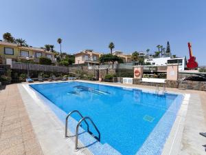 a large swimming pool with blue water at Fantastic holiday home in Playa del Ingles a few meters from the beach in Playa del Ingles