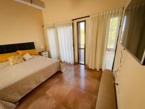 a bedroom with a bed and a sliding glass door at Andelka-Chumamaya Merlo San Luis in Merlo +35 photos
