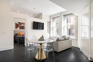a living room with a table and a couch at Orange Stay Apartments Potts Point in Sydney
