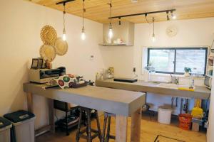 a kitchen with a table and a sink in a room at 1日1組様限定 黒姫山の絶景を楽しむ貸切サウナ付き一軒家 in Shinano