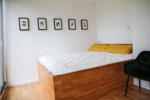 a bed in a bedroom with pictures on the wall at Sjö Hus in KÃ¶hn