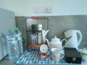a counter top with cups and bottles of water at Style Villa in Bentota
