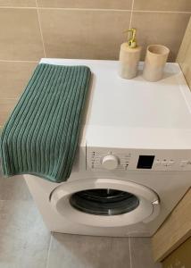 een groene handdoek bovenop een wasmachine bij RELOCKEY CANNES ACCOMODATION in Le Cannet