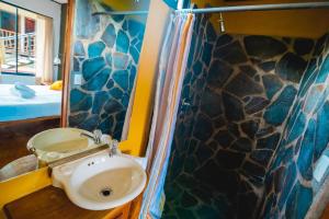 a bathroom with a sink and a shower at Pension Santa Elena in Monteverde Costa Rica