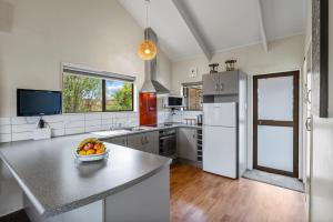 a kitchen with a bowl of fruit on a counter at Greenhaven with wi-fi in Taupo
