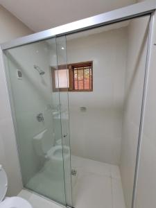 a glass shower in a bathroom with a toilet at Sur Backpackers in Santa Cruz de la Sierra +74 photos