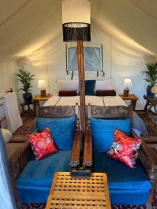 a living room with a couch and a bed at Wingtons Glamping in Clarence Point