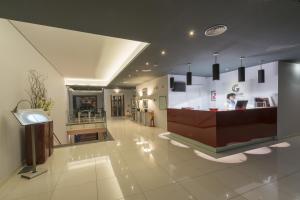 a lobby with a reception desk in a building at Vila Gale Collection Douro in Lamego