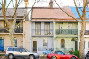 two cars parked in front of a house at Cozy 3 bedroom terrace in CBD in Sydney