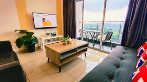 a living room with a couch and a large window at Kulai d putra suites beside ioiMall near JPO and Airport in Kulai