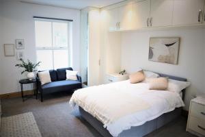 een slaapkamer met een bed, een stoel en een raam bij Camden, London, Holloway Rooms in Londen
