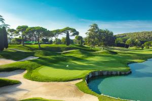 an aerial view of a golf course with a pond at Hidden garden Central and quiet rest in Barcelona