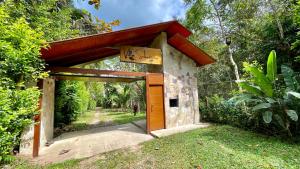 a small building with a gate with a sign on it at Villa Sebastiana Bungalows in Tarapoto