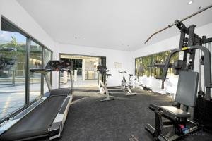 a gym with treadmills and bikes in a room at Ipanema Holiday Resort in Gold Coast