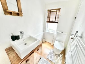a white bathroom with a sink and a mirror at New Brighton Beach in Wallasey +50 photos
