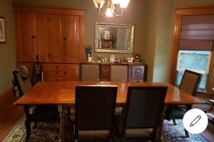 a dining room with a wooden table and chairs at Cummings Place AirBNB in Wellsville