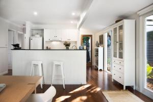 a kitchen with white cabinets and a counter top at Campari in Daylesford