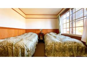 Postel nebo postele na pokoji v ubytování Hakuba Pension Meteor - Vacation STAY 63331v