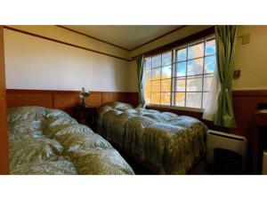 מיטה או מיטות בחדר ב-Hakuba Pension Meteor - Vacation STAY 63331v