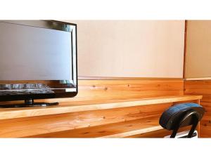 a flat screen tv sitting on top of a wooden table at Hakuba Pension Meteor - Vacation STAY 63342v in Hakuba