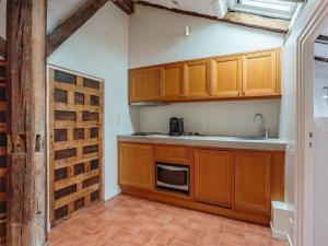 a kitchen with wooden cabinets and a sink at Charmant T3 sous les toits, centre historique de St-Jean-de-Luz, proche plage et commerces - FR-1-4-681 in Saint-Jean-de-Luz +6 photos