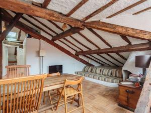 a living room with a wooden table and a couch at Charmant T3 sous les toits, centre historique de St-Jean-de-Luz, proche plage et commerces - FR-1-4-681 in Saint-Jean-de-Luz