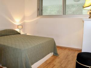 a bedroom with a bed and two windows at Appartement Villeneuve-Loubet, 2 pièces, 4 personnes - FR-1-252A-113 in Villeneuve-Loubet