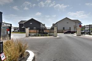 a street with houses and a gate with a stop sign at New 3 Bedroom Vacation Home Lackland/Sea World/La Cantera in San Antonio