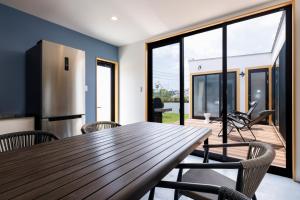 a kitchen and dining room with a wooden table and chairs at VILLA SOUTH COAST SHIMA in Hamajima