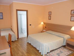 Postel nebo postele na pokoji v ubytování Hotel Ristorante Al Bassanello