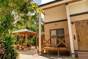 a house with a wooden door and a pavilion at Nakijin Lodge ぺんさじょうやー in Nakijin