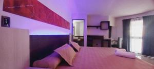 a bedroom with a large bed in a room at Golden Ross Resort & Spa in Villa Carlos Paz