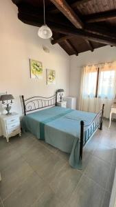 a bedroom with a large bed with a blue bedspread at Guest House Vela Blu in Santa Marinella