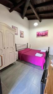 a bedroom with a large bed with pink sheets at Vela Blu in Santa Marinella