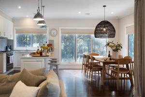 a kitchen and living room with a table and chairs at Cooinda in Trentham