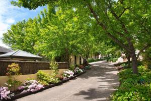a walkway with flowers and trees in a yard at Courthouse Merindah 4 in Daylesford +5 photos