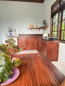 a kitchen with a wooden table with a plant on it at Twin Inn in Ubud +23 photos