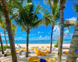 a beach with palm trees and a bunch of yellow stuff at MOONLIGHT HOTEL in Ha Long