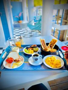 a tray of breakfast foods on a table at Lindsey Hôtel in Saint-Pierre
