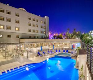 a view of a hotel pool at night at Geneva Hotel in Amman