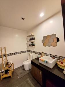 a bathroom with a white toilet and a sink at Pool Villa 3bedroom Bann Anda by fantaseabeachpattaya in Nong Prue