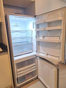 an empty refrigerator with its door open in a kitchen at Pool Villa 3bedroom Bann Anda by fantaseabeachpattaya in Nong Prue +15 photos